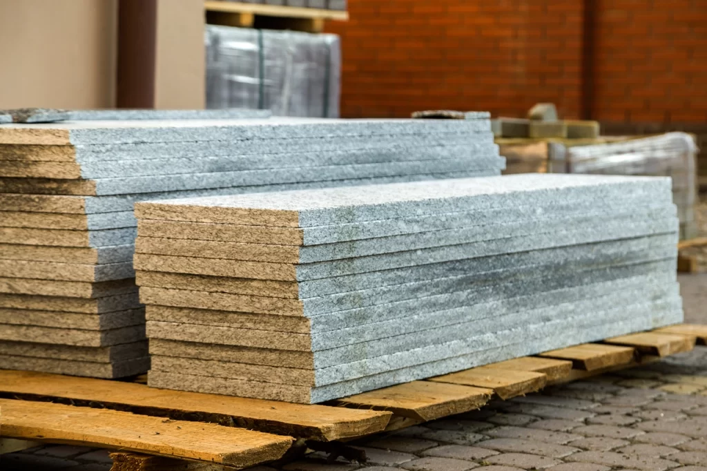 Piles of granite marble slabs. Stone sheets for decorative construction