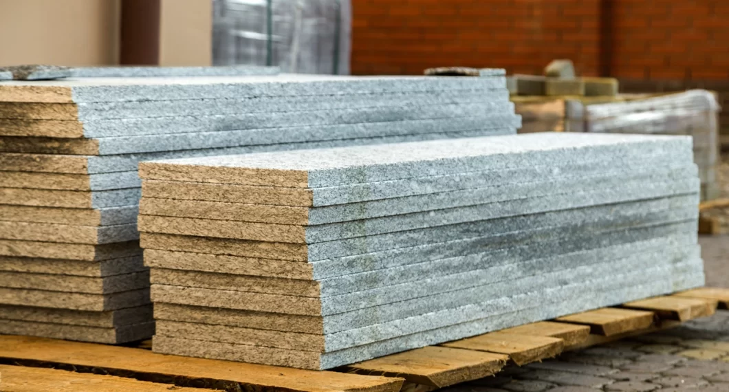 Piles of granite marble slabs. Stone sheets for decorative construction
