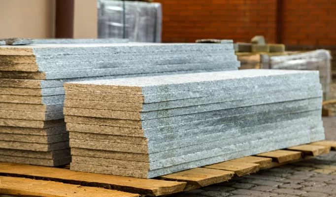 Piles of granite marble slabs. Stone sheets for decorative construction