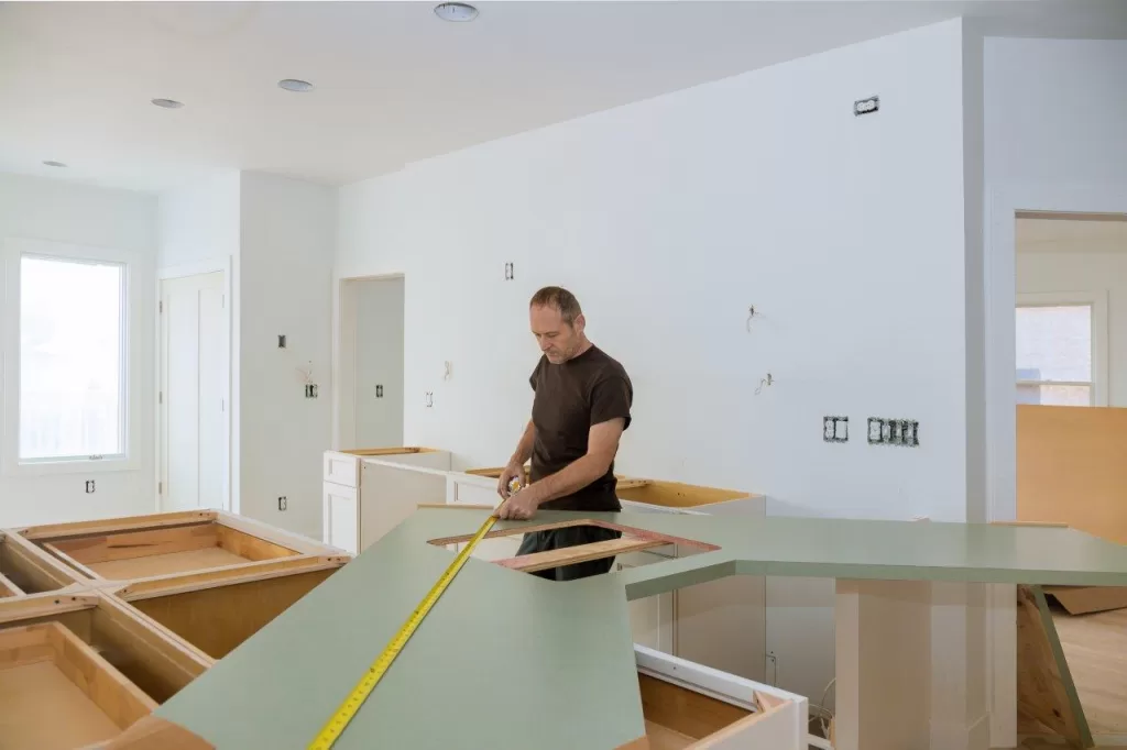 Construction worker is measuring Countertop for kitchen