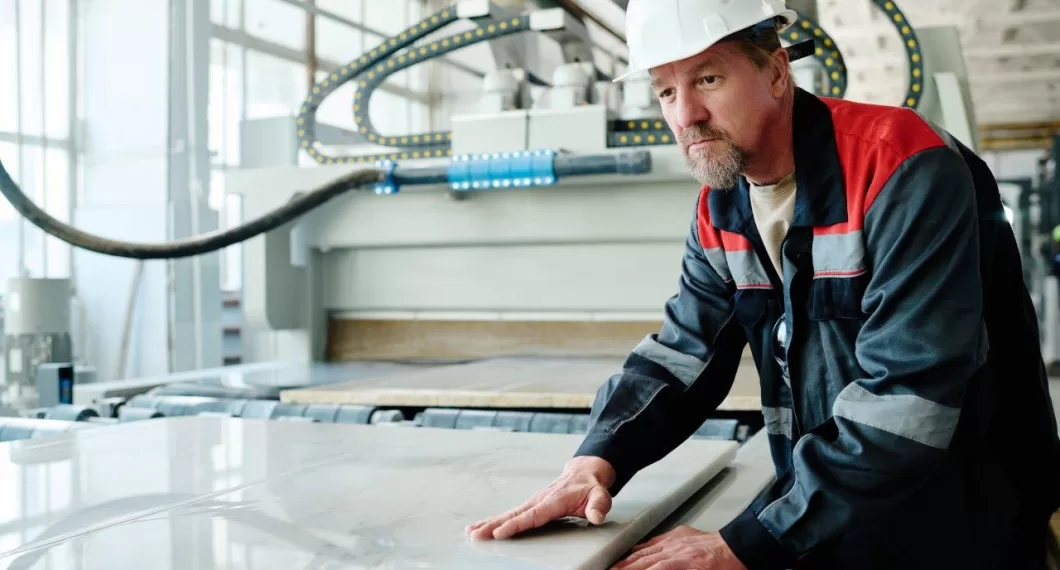 worker cutting marble in factory