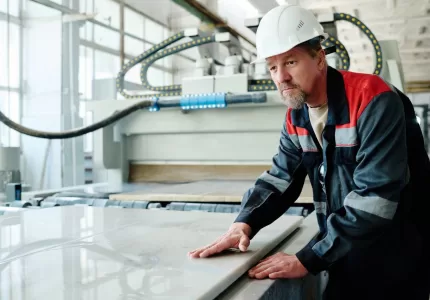 worker cutting marble in factory
