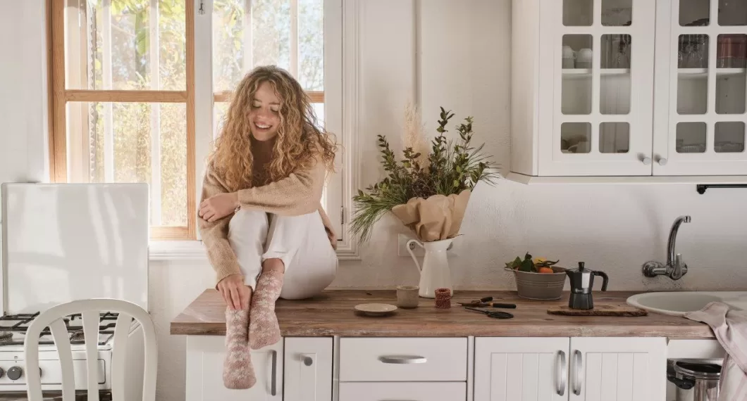 young woman sitting in kitchen