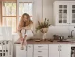 young woman sitting in kitchen