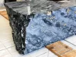 Block of black portoro marble on workshop floor