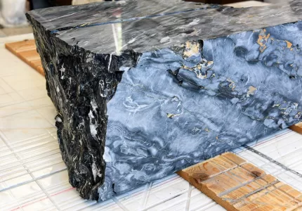 Block of black portoro marble on workshop floor