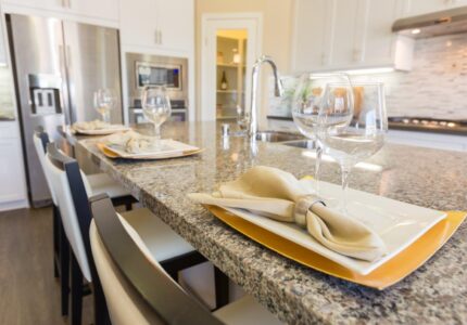 Abstract of Beautiful Kitchen Granite Counter Place Settings and Chairs