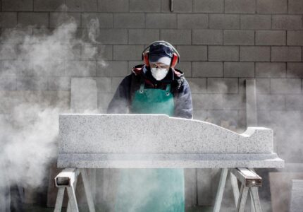 craftsman-meticulously-shaping-stone-amidst-a-clouds